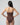 Woman wearing a brown strapless swimsuit against a gray background