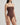 Brown strapless swimsuit worn by a model on a light gray background