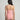 Person wearing a pink strapless swimsuit against a gray background