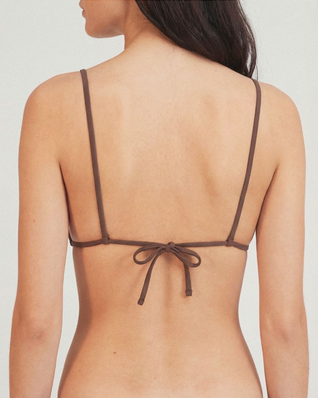 Brown triangle bikini top on a plain background
