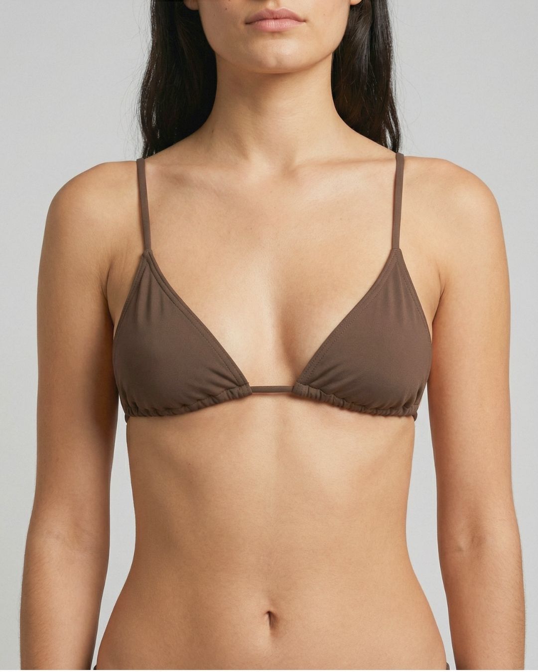 Brown bra worn by a model on a plain background