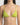 Green bikini top worn by a person on a plain background