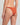 Orange bikini bottom worn by a person on a plain background