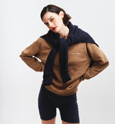 Girl posing wearing masara cacao sweatshirt and navy blue wrapped around her shoulders