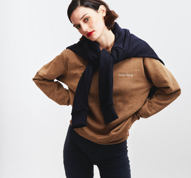 Girl posing wearing masara cacao sweatshirt and navy blue wrapped around her shoulders