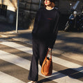 Girl crossing the street wearing masara navy blue and red sweatshirt and navy blue hat 