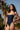 Woman wearing blue swimsuit on promenade