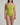 Woman wearing a green swimsuit against a plain background