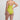 Woman wearing a lime green swimsuit on a light gray background