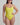 Woman wearing a yellow one-piece swimsuit against a plain background