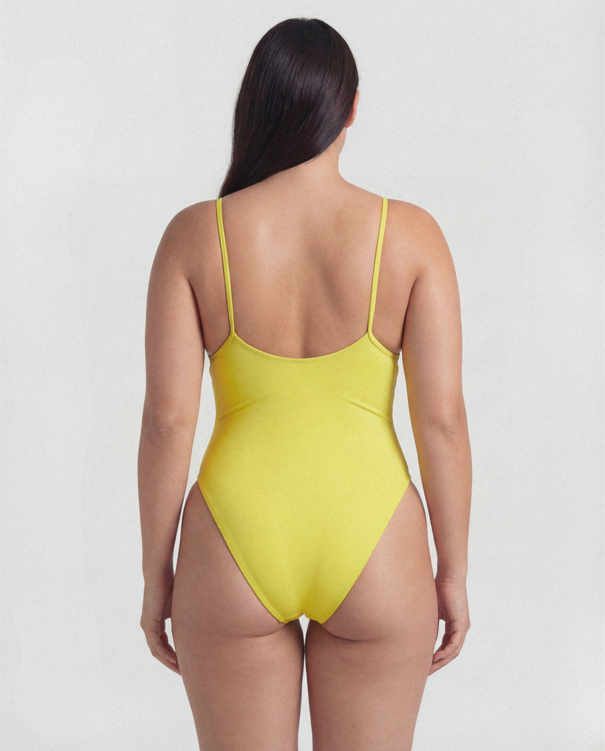 Yellow swimsuit worn by a person on a white background