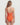 Woman wearing an orange swimsuit on a white background