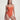 Woman wearing an orange swimsuit against a plain background