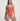 Woman wearing an orange swimsuit against a plain background