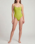 Person wearing a green one-piece swimsuit on a plain background