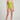 Person wearing a green one-piece swimsuit on a plain background