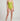Person wearing a green one-piece swimsuit on a plain background
