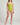 Person wearing a green one-piece swimsuit on a plain background