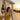 Woman in a yellow swimsuit holding a glass of wine by a poolside at sunset.