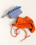 Masarà Yaya Sarong in Paprika Orange with the Occhio print zip pouch