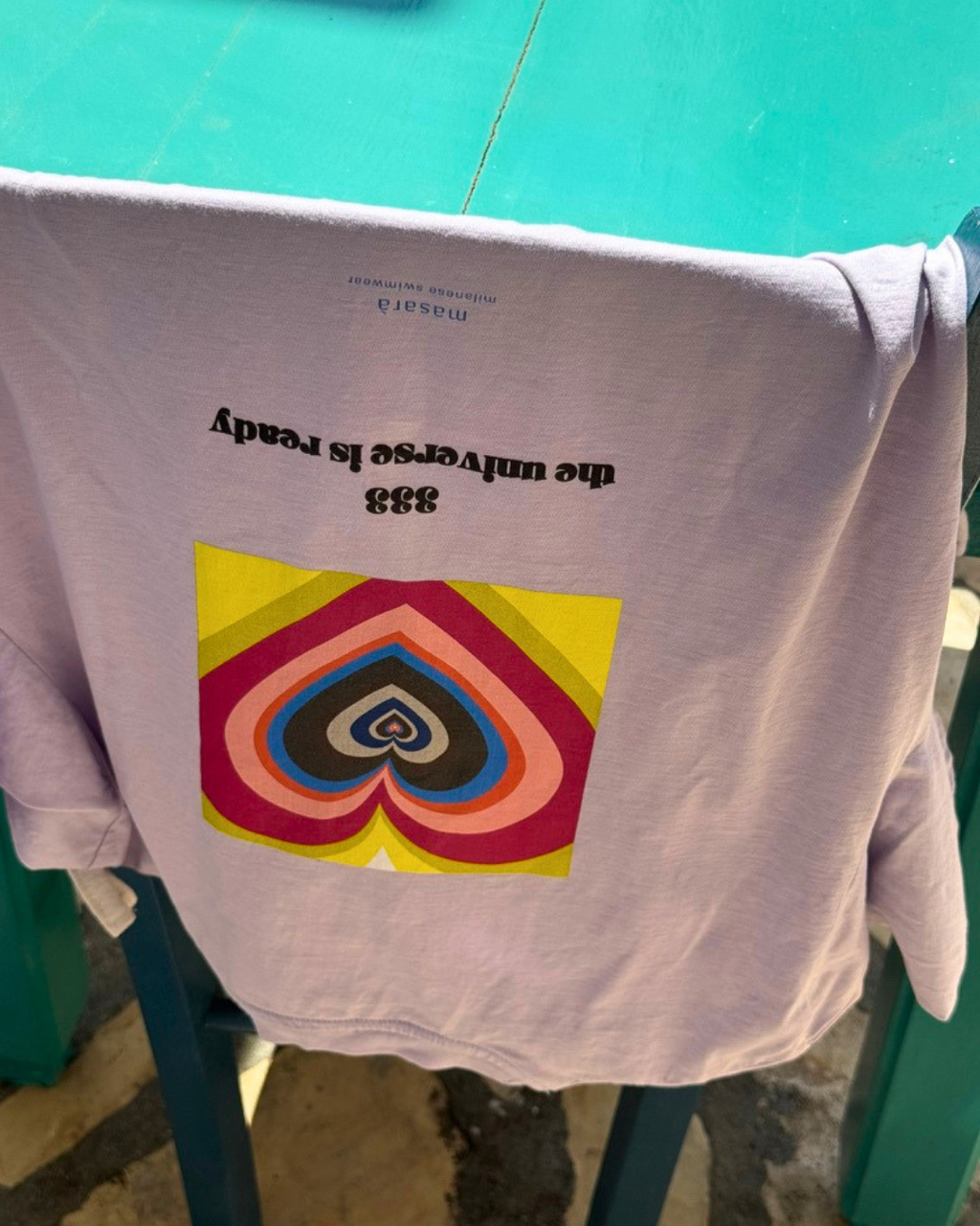 Model wearing the Universe Ready Tee, with the 333 the universe is ready artwork printed on the back