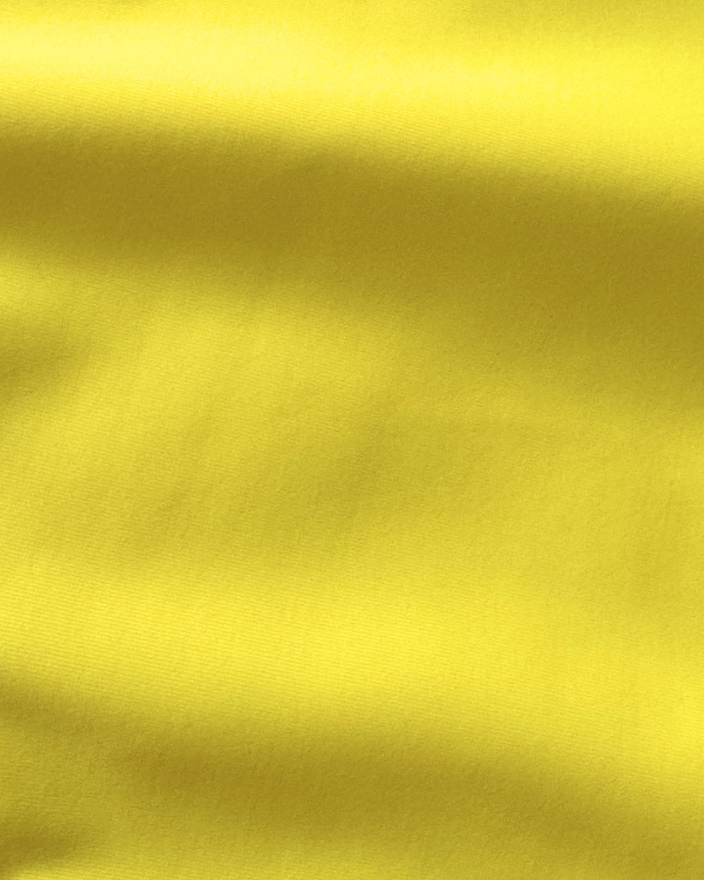 Close-up of yellow regenerated nylon fabric with folds