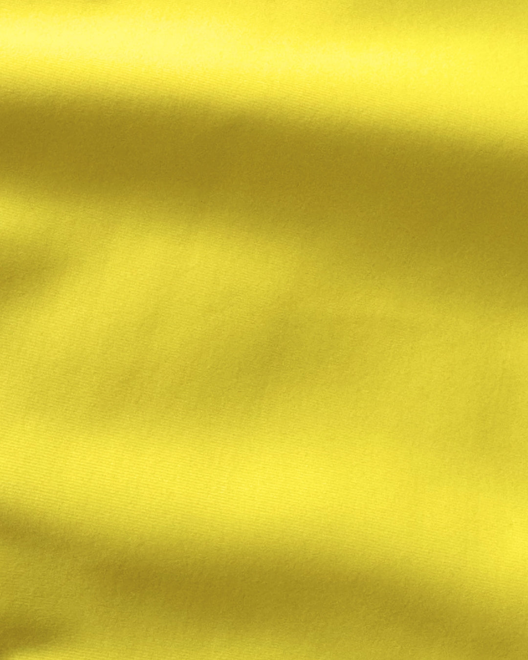 Close-up of yellow regenerated nylon fabric with folds