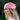 Woman wearing a pink headscarf with a blurred green background