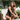 Woman sitting outdoors on a chair with a blurred background