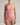 Pink halter neck swimsuit worn by a model on a plain background
