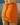 Orange skirt worn by a person with a blurred natural background