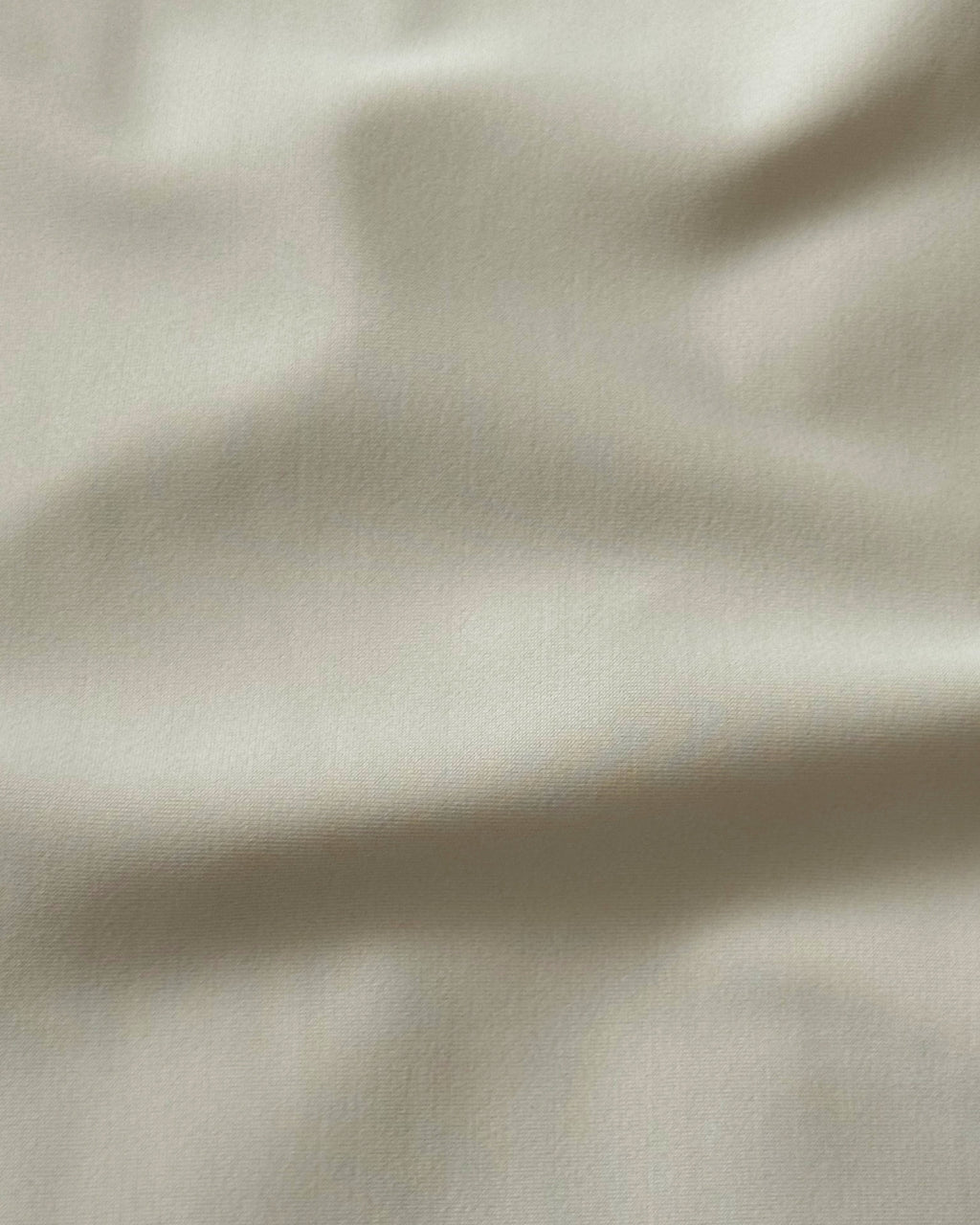 Close-up of beige regenerated nylon  fabric with subtle texture