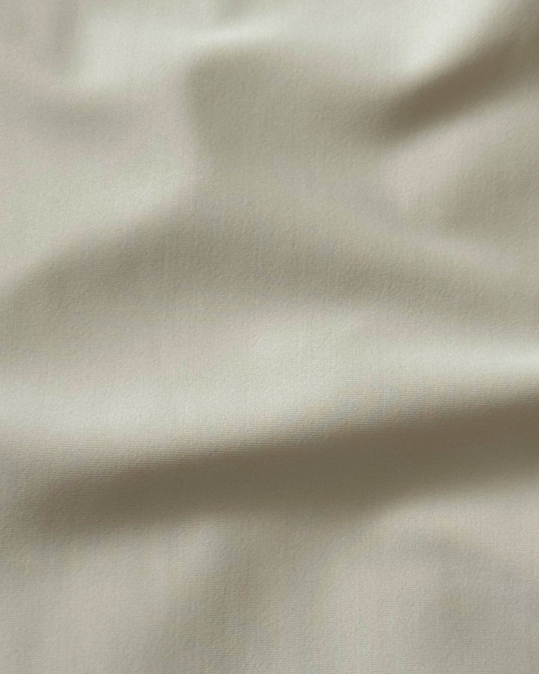 Close-up of beige regenerated nylon  fabric with subtle texture