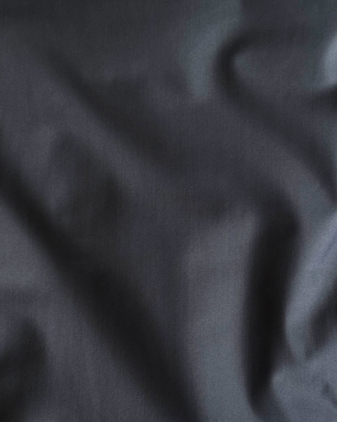 Close-up of dark gray regenerated nylon fabric texture