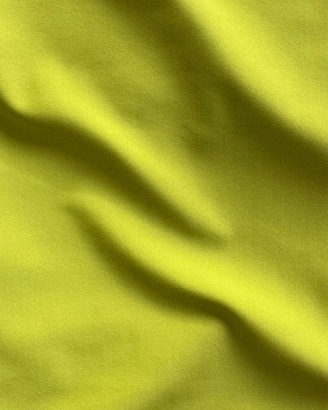 Close-up of green regenerated nylon fabric with visible texture