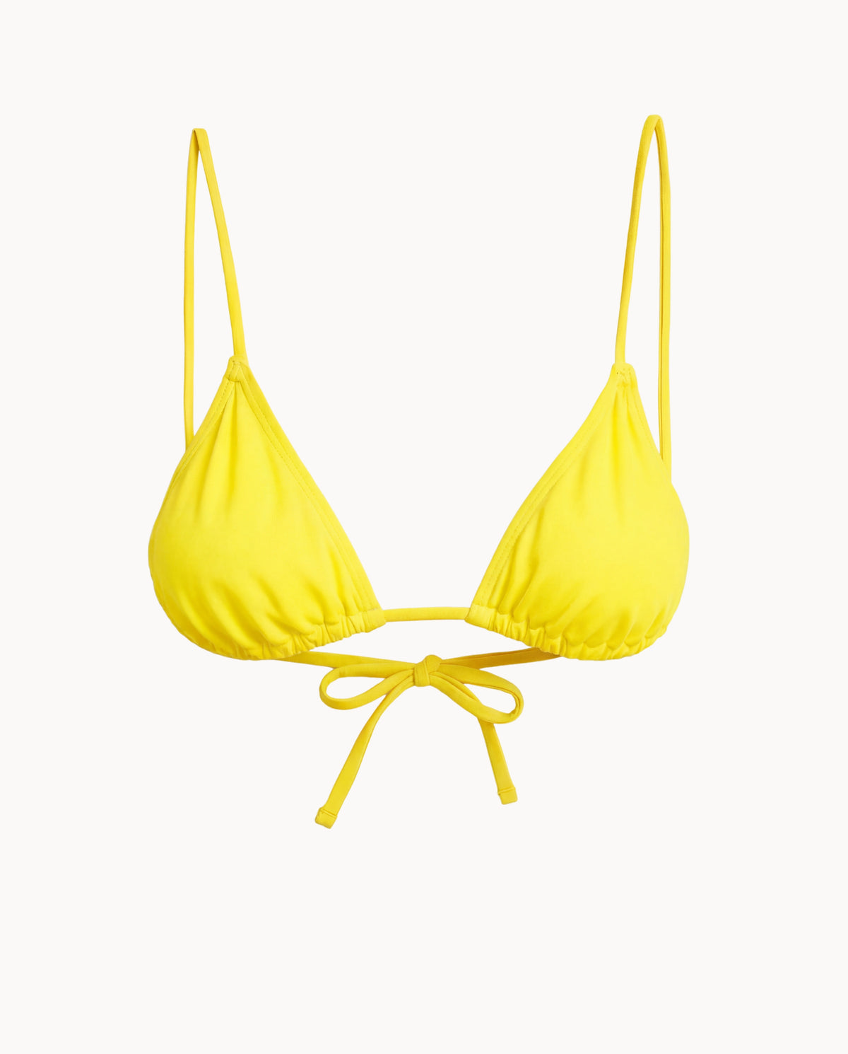 Yellow bikini top with thin straps on a white background