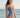 Woman wearing a blue and white polka dot swimsuit on a beach