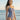 Woman wearing a blue and white polka dot swimsuit on a beach