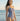 Woman wearing a blue and white polka dot swimsuit on a beach