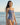 Woman wearing a blue and white polka dot swimsuit on a beach