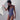 woman in outdoor shower wearing bathing suit with evil eye pattern